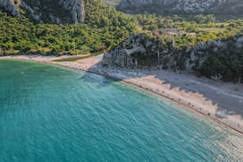 Stunning aerial image of Olympos beach, surrounded by lush forests and majestic mountains in Antalya, Türkiye.
